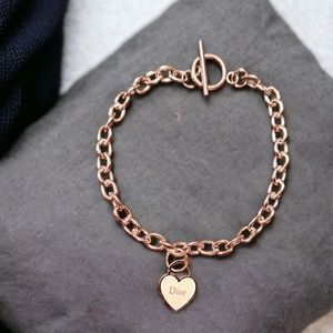 Heart shaped emblem on a stainless steel bracelet